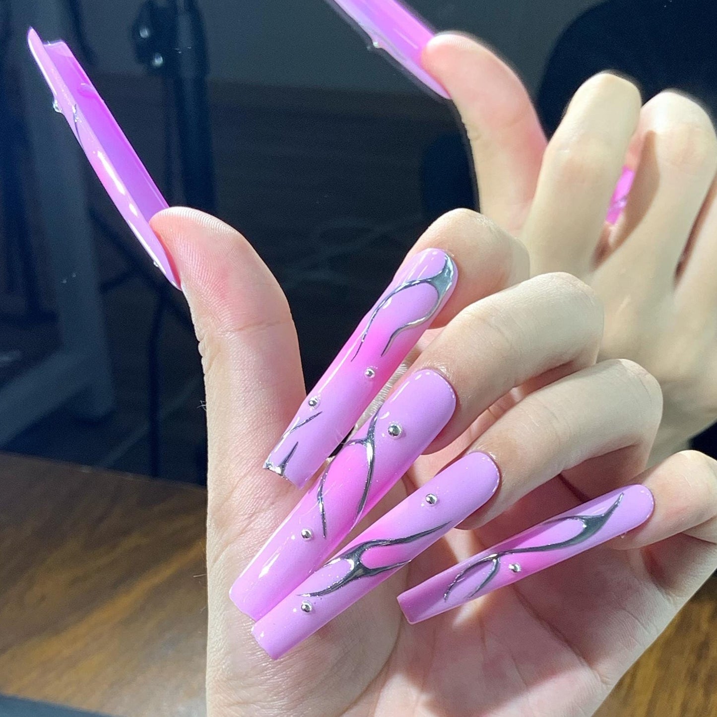 Pink nails chrome long coffin nails, press-on nails, abstract nail art, glossy metallic accents elegant manicure, silver swirl trendy pink