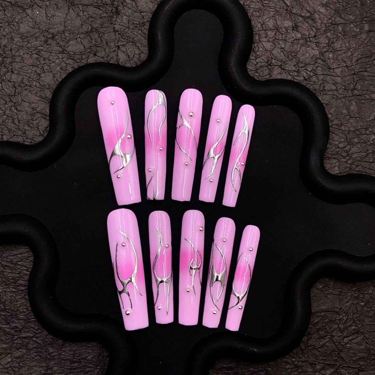 Pink nails chrome long coffin nails, press-on nails, abstract nail art, glossy metallic accents elegant manicure, silver swirl trendy pink