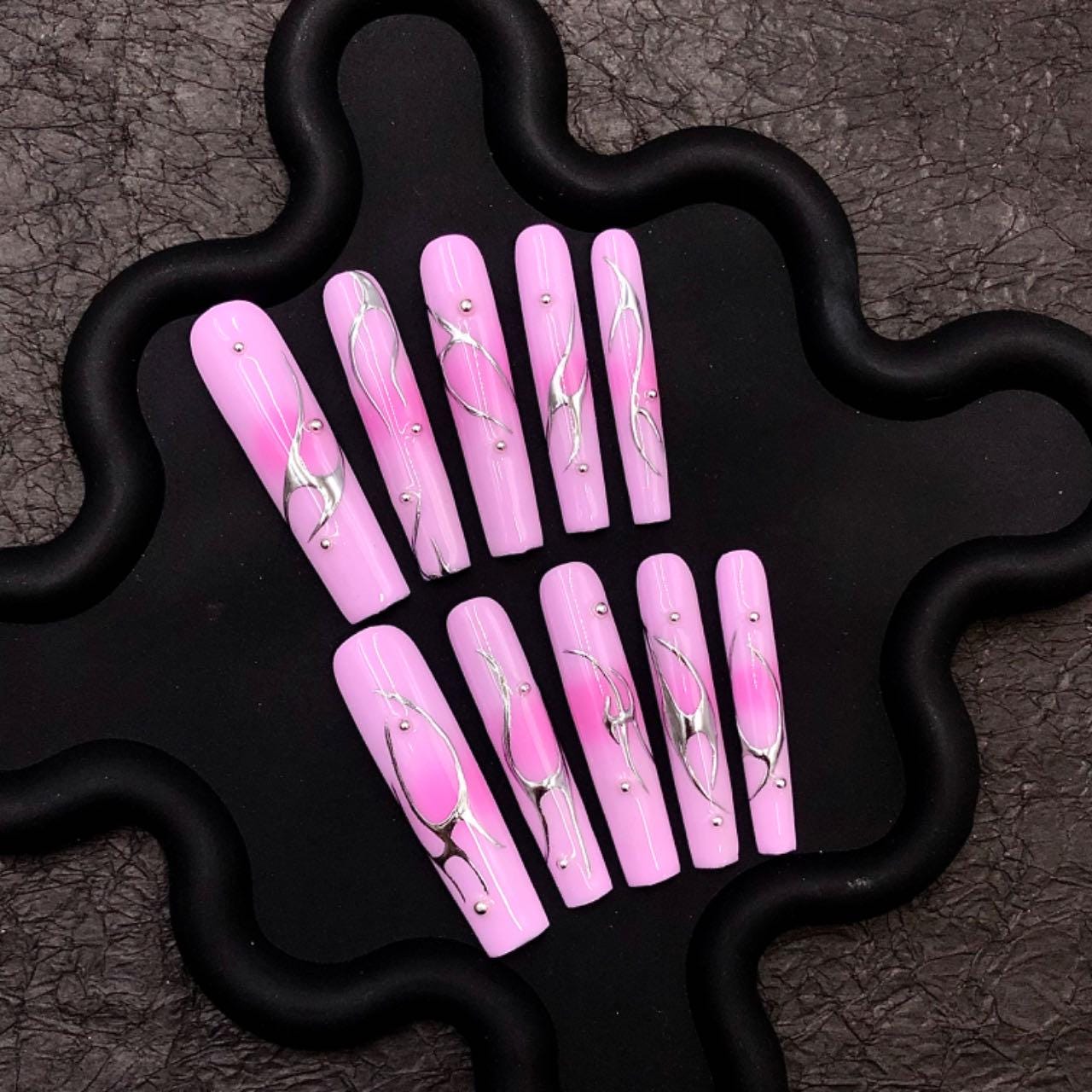 Pink nails chrome long coffin nails, press-on nails, abstract nail art, glossy metallic accents elegant manicure, silver swirl trendy pink