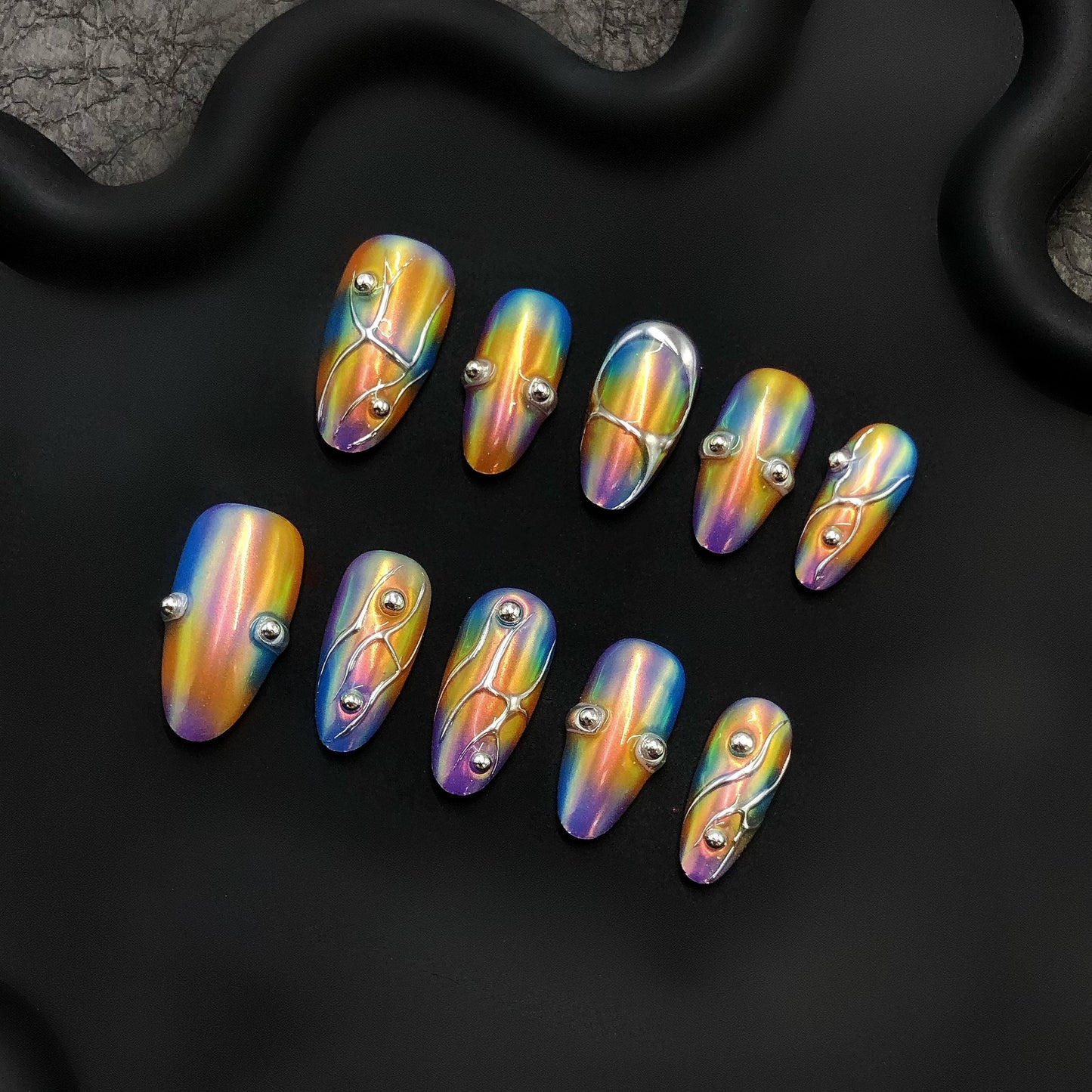 Chrome holographic rainbow metallic press-on iridescent 3D art, silver bead embellishments, abstract futuristic shiny almond nails, glossy