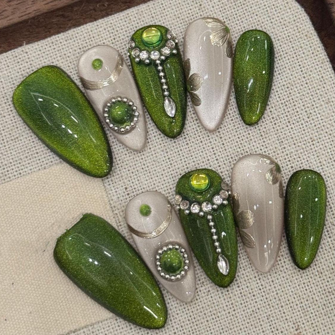 Emerald Envy Press-On Nails – Green & Gold Gemstone Glam Set glue on luxe medium almond emerald green champagne shimmer ornate rhinestones