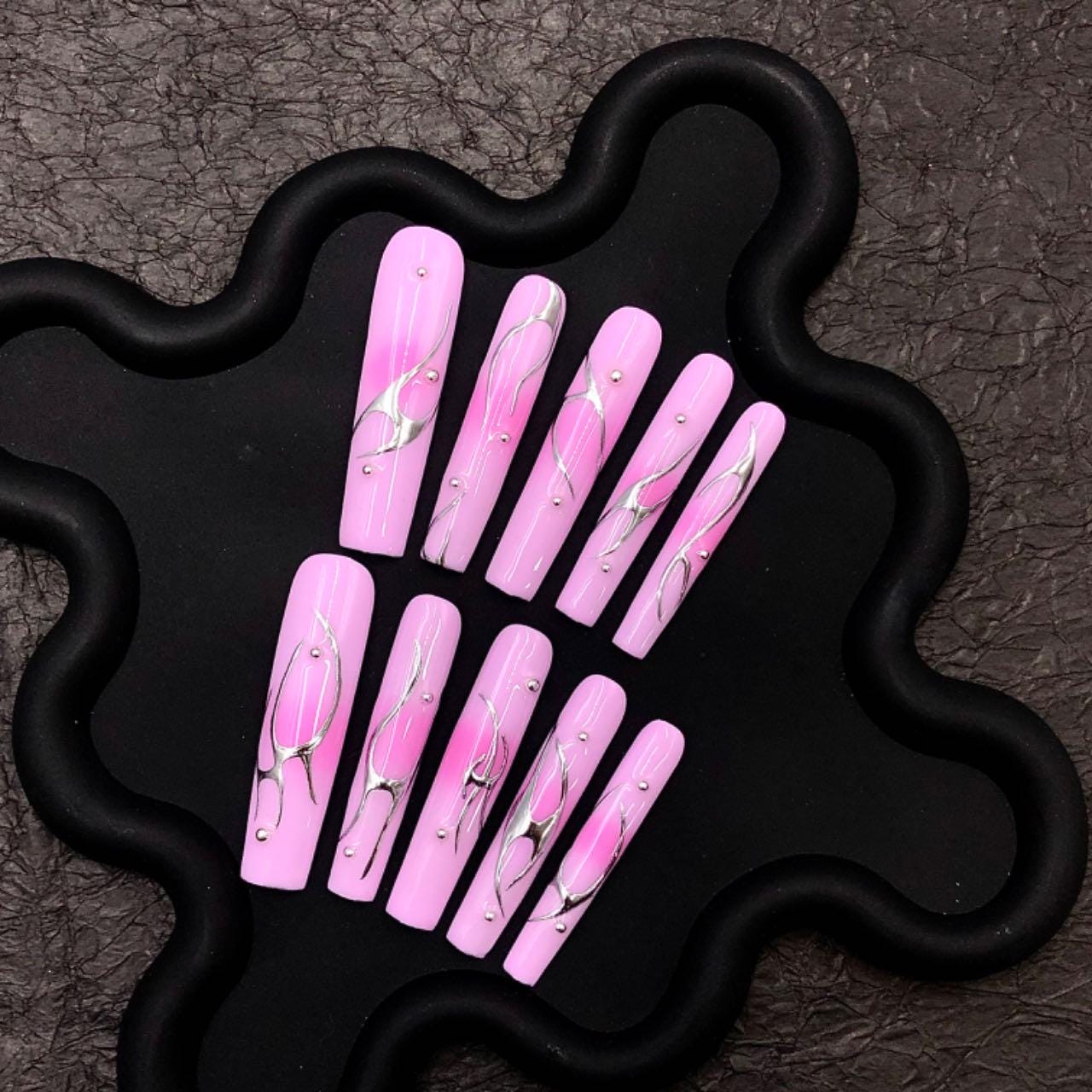 Pink nails chrome long coffin nails, press-on nails, abstract nail art, glossy metallic accents elegant manicure, silver swirl trendy pink