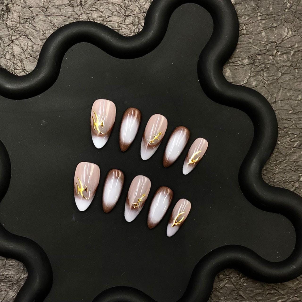 Nude black ombré nails almond-shaped press-on gold nail art elegant manicure minimalist nail style modern nail fashion, glossy subtle luxury