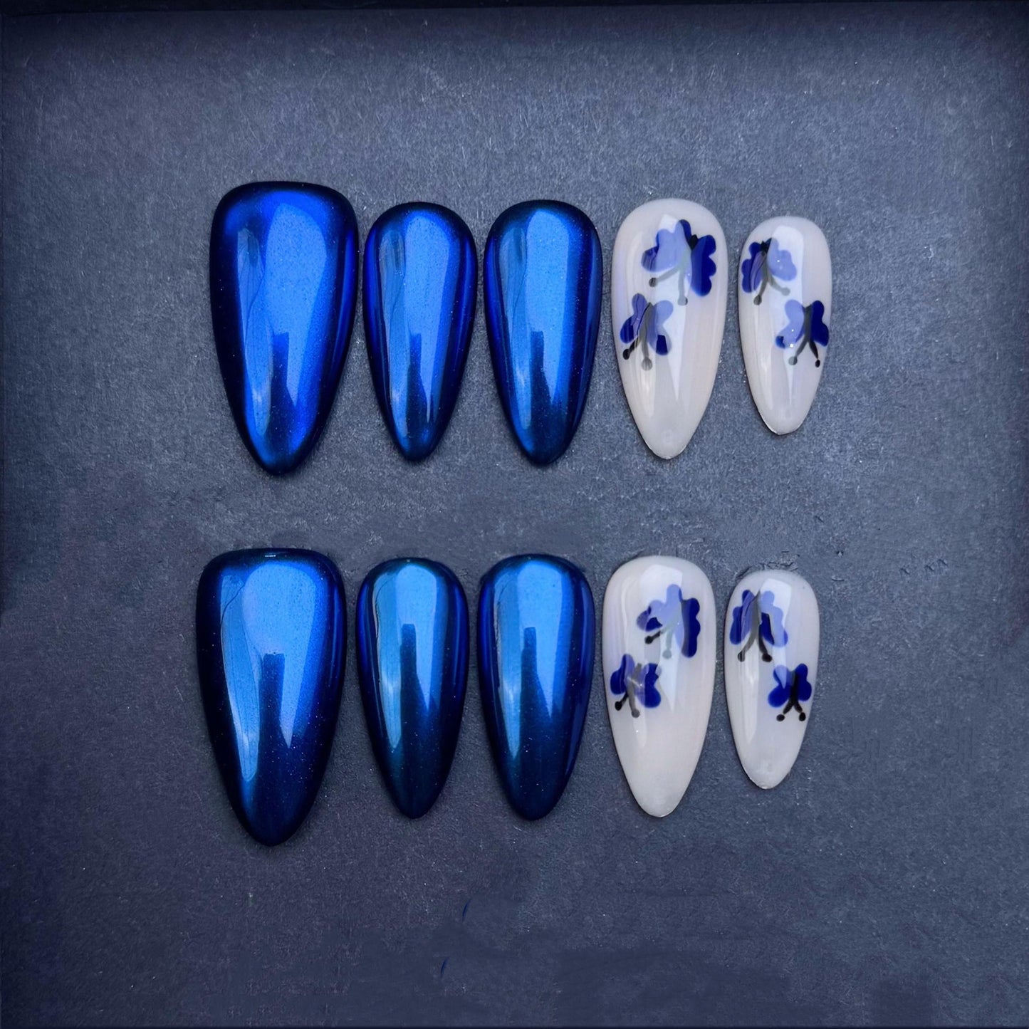 Iridescent Sapphire Blue and Floral White Press-On Nails. Artificial reusable fake glue on faux manicure nails trendy art.