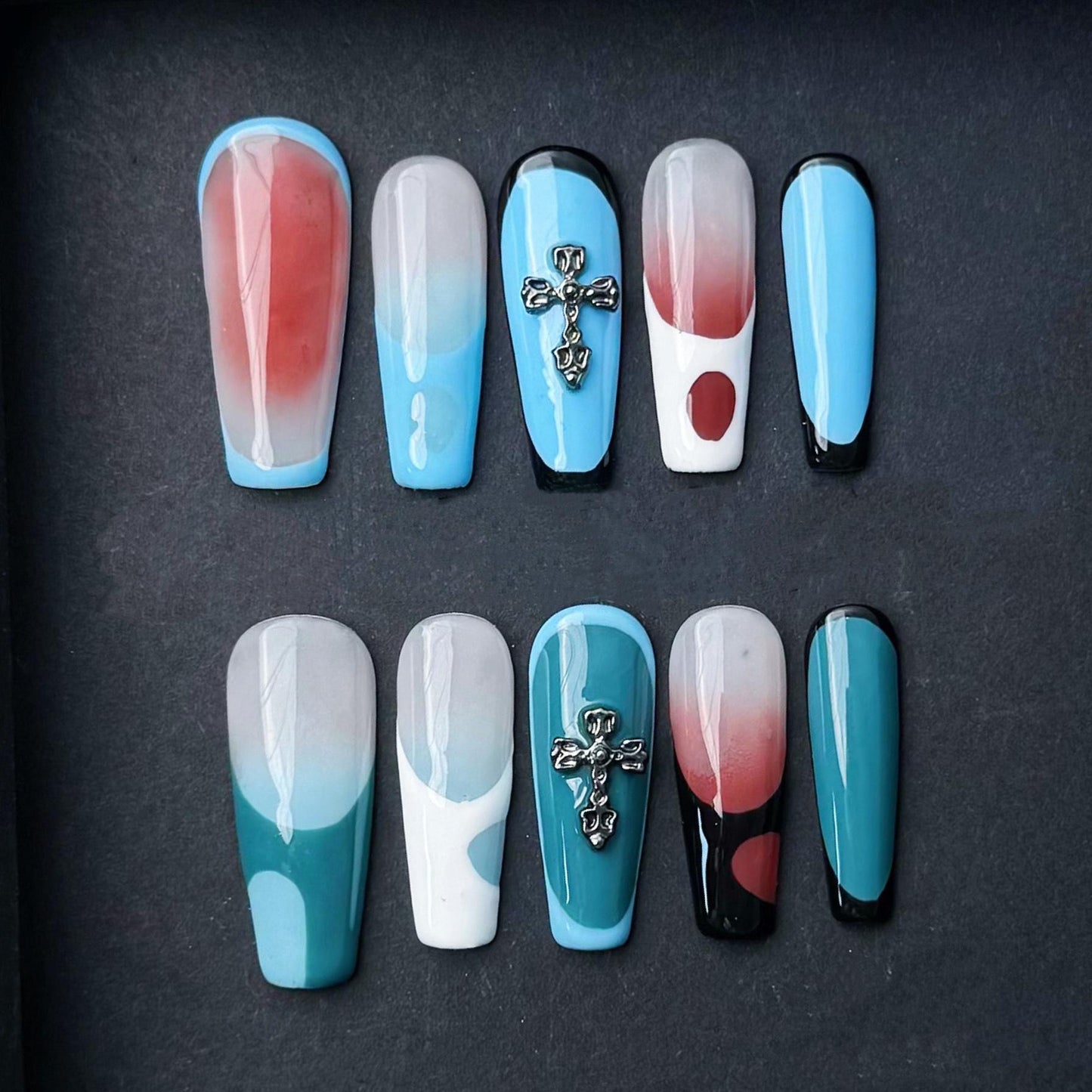 Modern Abstract Press On Nails with Cross Charm Red Teal and Sky Blue Color Blocking. Artificial fake glue on faux manicure nail trendy art.