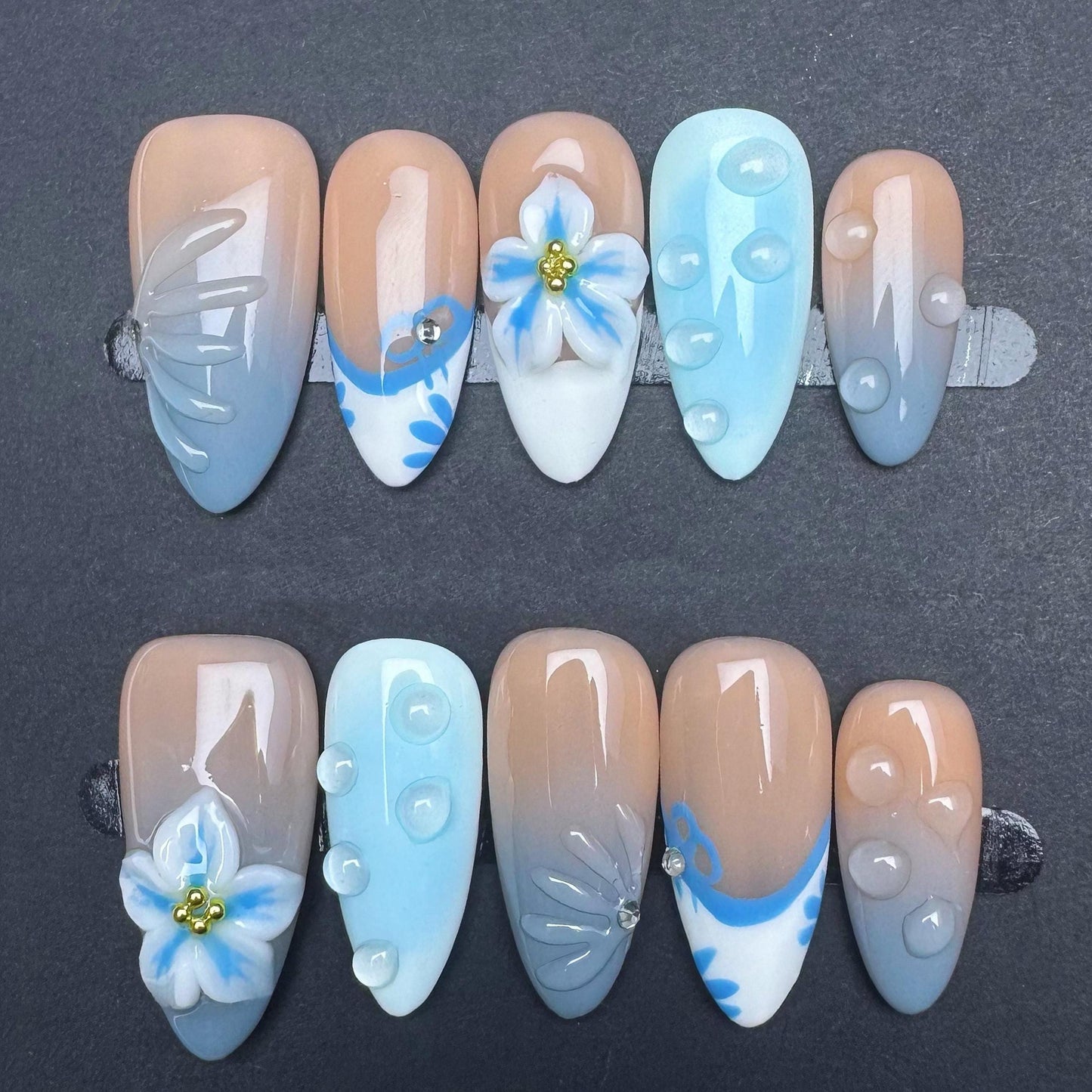 Soft Blue Gradient Floral Press-On Nails with 3D Embellishments. Artificial reusable fake glue on faux manicure nails trendy art.