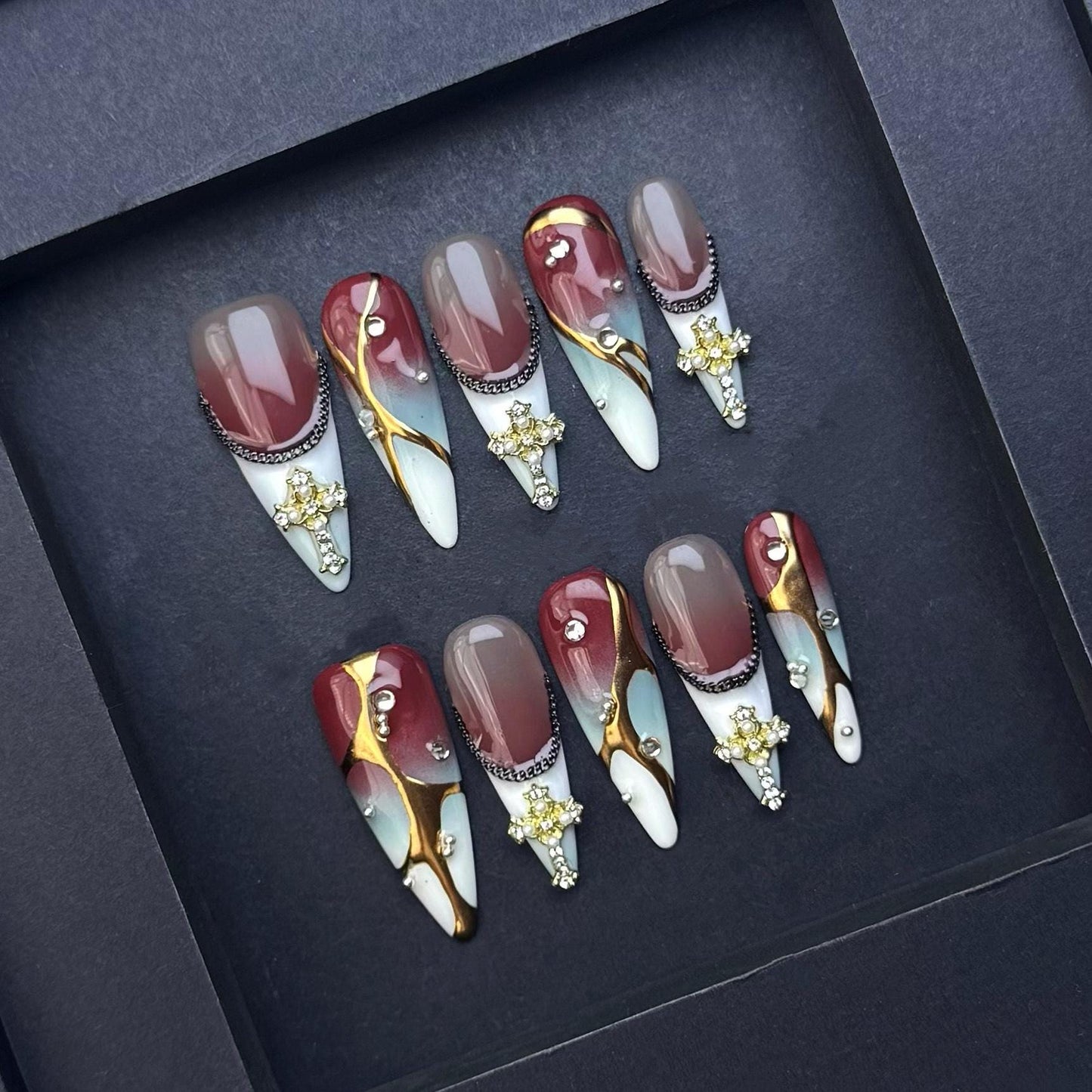 Gothic Elegance Press-On Nails with Gold Cross Charms. Burgundy and Marble Stiletto Set. Artificial reusable glue on faux nails trendy art.