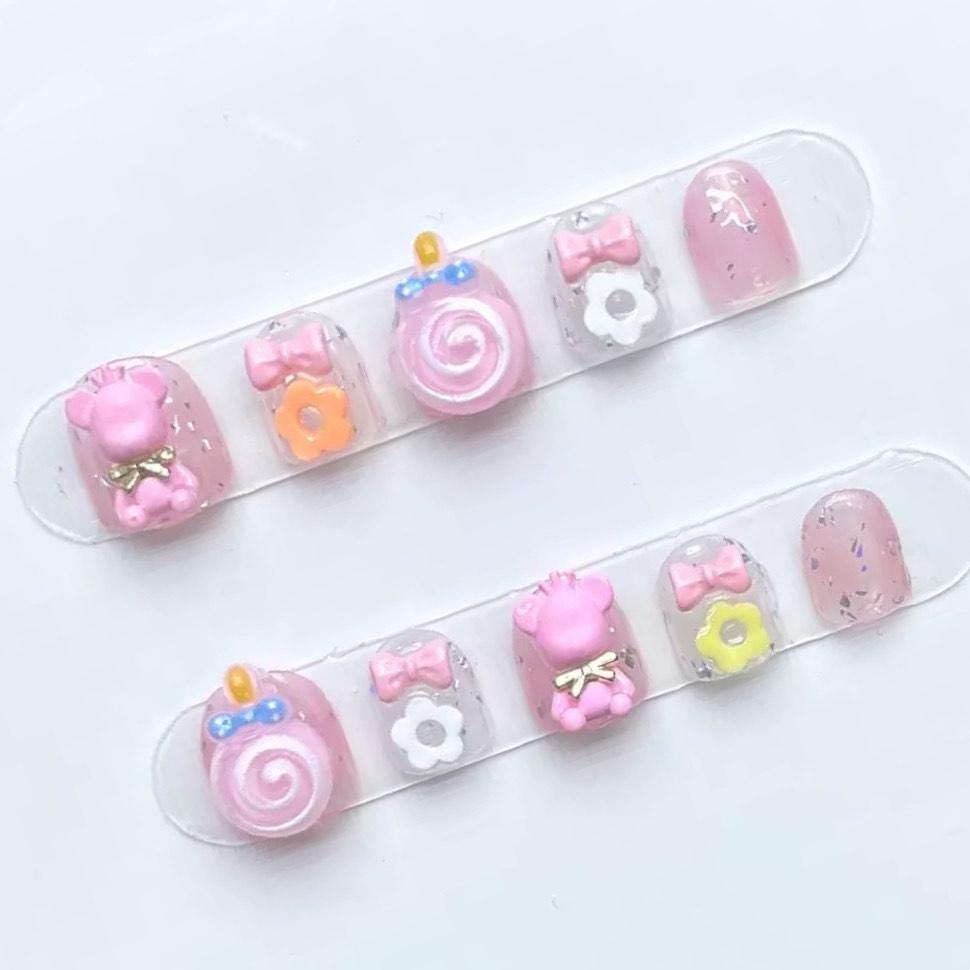 Pink Candy Bear Press On Nails for Kids with 3D Lollipop Flowers Bows and Glitter Accents. Artificial faux manicure nails trendy art.