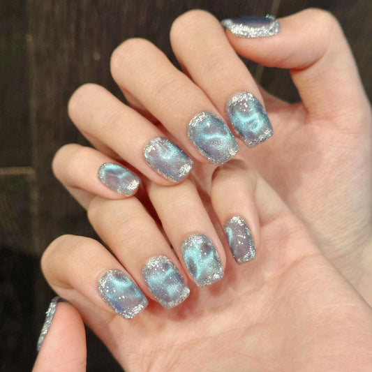 Icy Blue Cat Eye Press On Nails with Chunky Silver Glitter Border Square Shape. Artificial reusable glue on faux manicure nails trendy art.