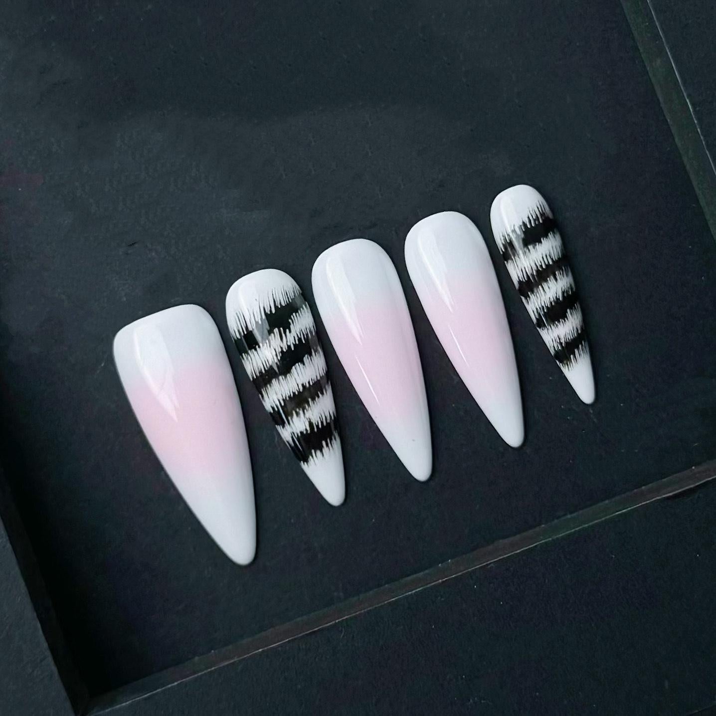 Pink and White Ombre Press On Nails with Black Abstract Zebra Stripe Accent. Artificial reusable fake glue on faux manicure nail trendy art.