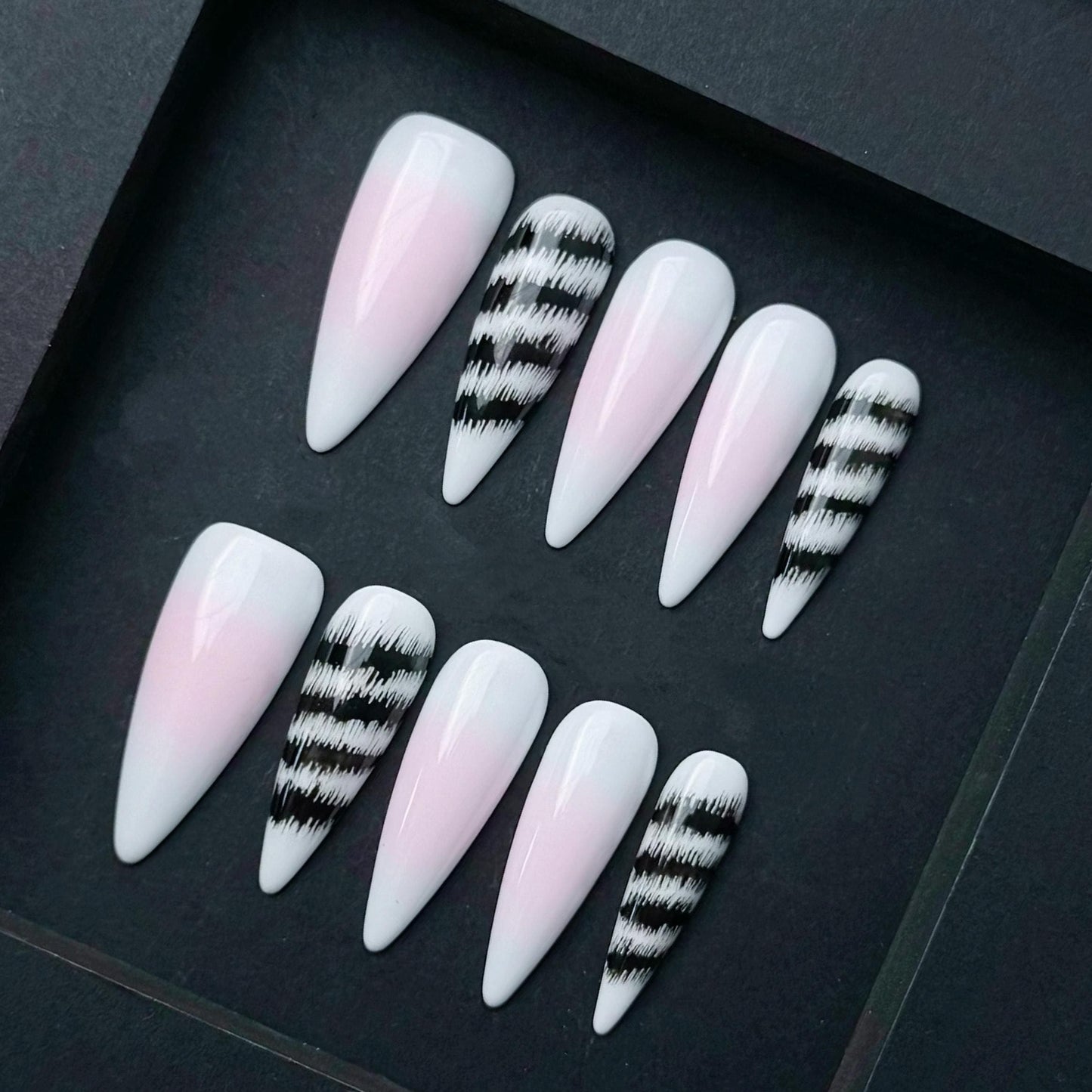 Pink and White Ombre Press On Nails with Black Abstract Zebra Stripe Accent. Artificial reusable fake glue on faux manicure nail trendy art.