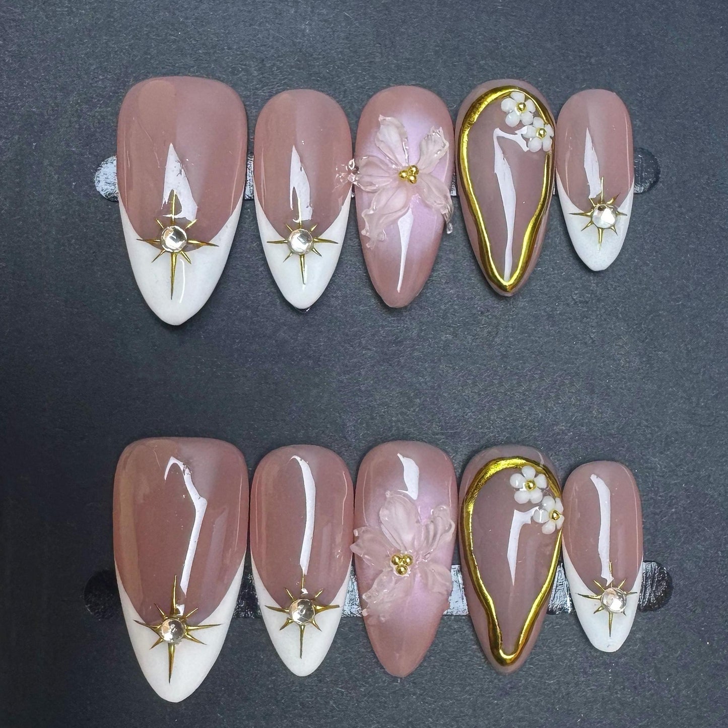 Elegant Nude Press On Nails with 3D Flower Gold Accents French Tips and Pearl Charms. Artificial fake glue on faux manicure nail trendy art.