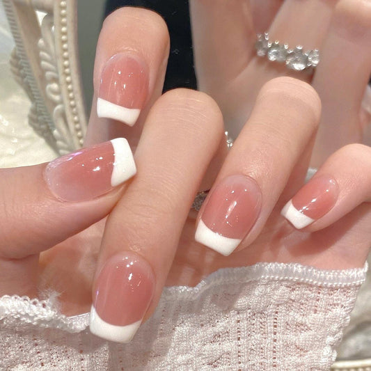 Classic French Tip Press-On Nails in Glossy Nude Pink. Artificial reusable fake glue on faux manicure nails trendy art.