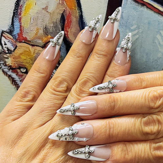 Nude and White French Tip Press-On Nails with Pearl Cross Charms. Artificial reusable fake glue on faux manicure nails trendy art.