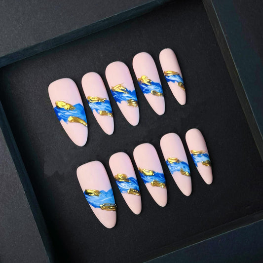 Matte Nude Press On Nails with Blue and Gold Textured Abstract Wave Design. Artificial reusable fake glue on faux manicure nails trendy art.