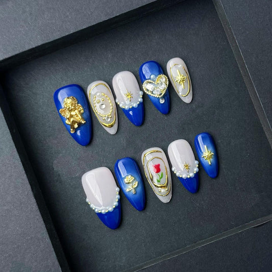 Royal Blue Angelic Pearl Press-On Nails with Gold Charms and Rose Accent. Artificial reusable fake glue on faux manicure nails trendy art.