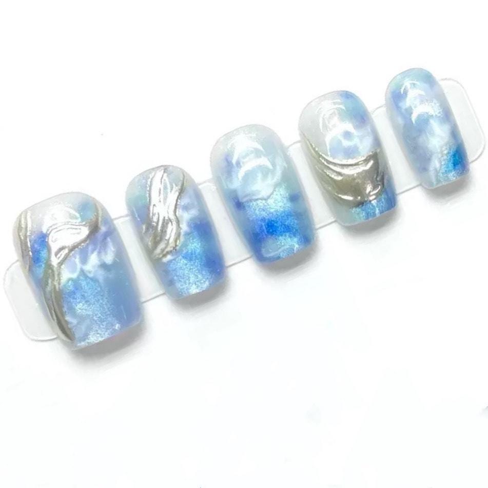 Ocean Swirl Blue Marble Press-On Nails with Silver Wave Accents. Artificial reusable fake glue on faux manicure nails trendy art.